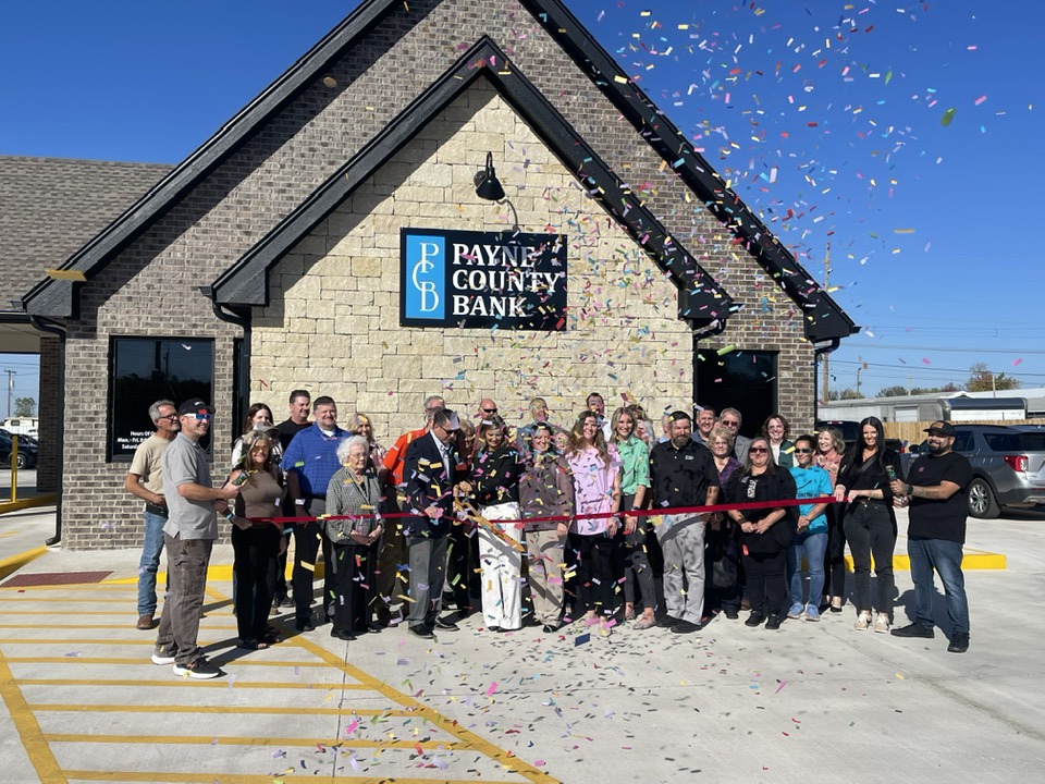 Chamber of Commerce ribbon cutting ceremony with local business owners and community leaders